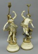 A pair of painted pewter figural lamps. 70 cm high overall.