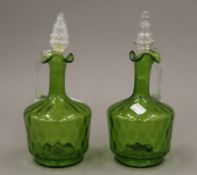 A pair of Victorian green glass ewers. 25 cm high.