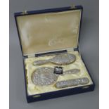 A boxed sterling silver dressing set.