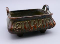 A Chinese bronze censer with Arabic calligraphy. 8 cm wide.