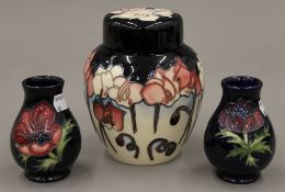 A pair of Moorcroft Anemone Tribute vases and a ginger jar. The latter 14.5 cm high.