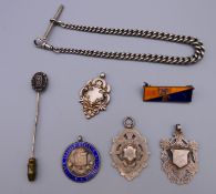 A silver watch chain, three silver watch fob medals,