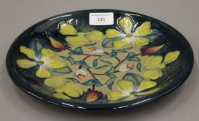 A Moorcroft Hypericum plate. 25.5 cm diameter.