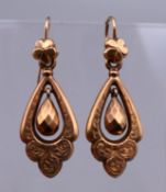 A pair of unmarked 9 ct gold drop earrings. 3.25 cm high. 2.5 grammes.