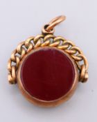 A 9 ct gold bloodstone and agate swivel fob pendant. 2 cm wide. 3.8 grammes total weight.