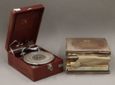 An HMV travelling gramophone and a quantity of records.