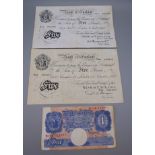 Two white £5 notes, one dated January 1945 signed Peppiatt,