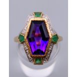 An Art Deco style 9 ct gold emerald, diamond and amethyst ring, in Suffragette colours.