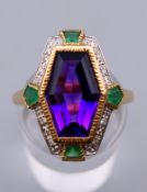 An Art Deco style 9 ct gold emerald, diamond and amethyst ring, in Suffragette colours.