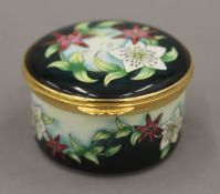 A boxed Moorcroft enamel Christmas Rose box. 5.5 cm diameter.