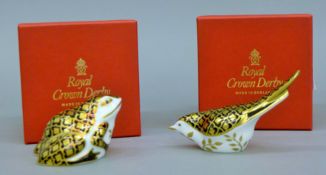 Two boxed Royal Crown Derby Aura design paperweights, frog and song bird.