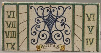 A Continental pottery tile, inscribed Sagitario. 27.5 cm long.