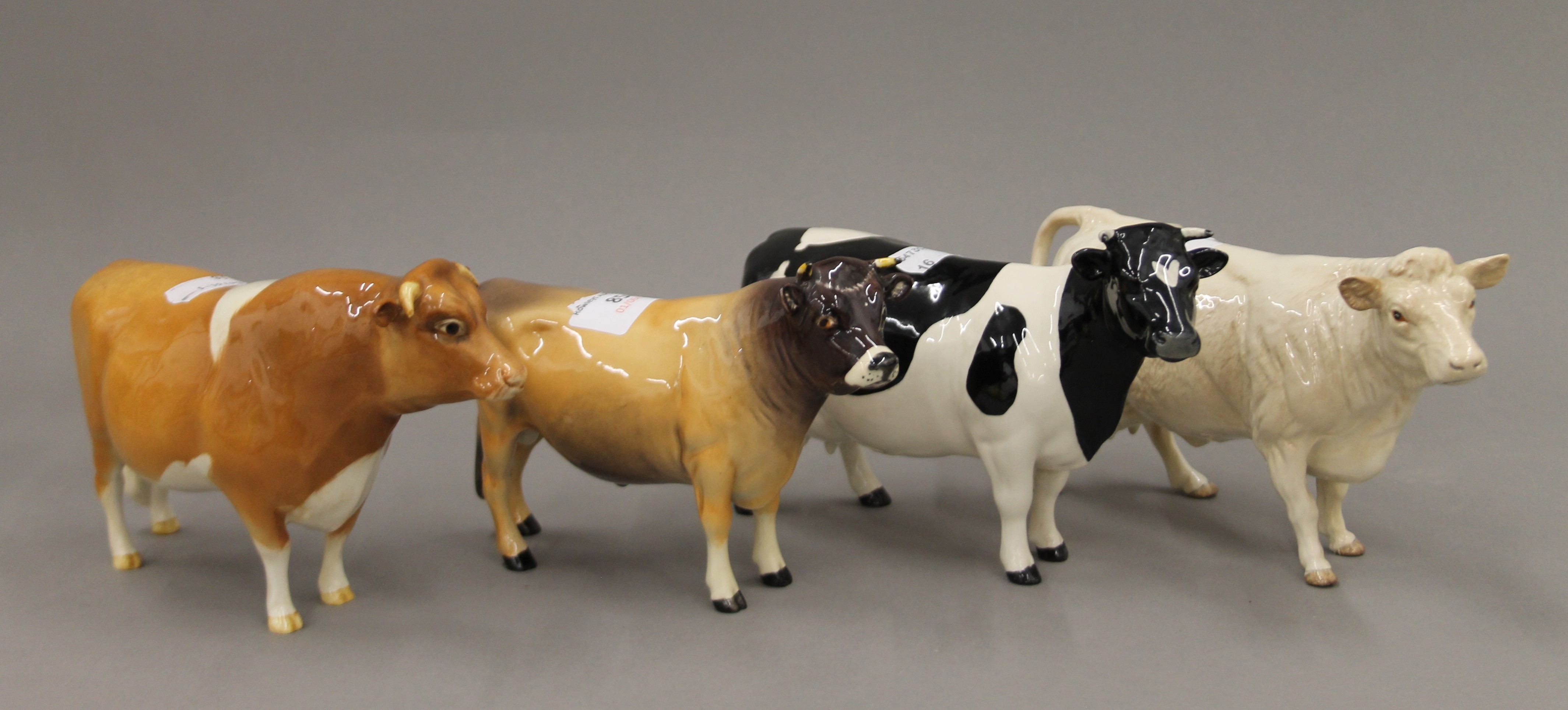 Four Beswick model cattle. The largest 11.5 cm high.