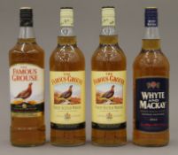Three bottles of Famous Grouse Finest Scotch Whisky and a bottle of Whyte and Mackay Smooth Scotch
