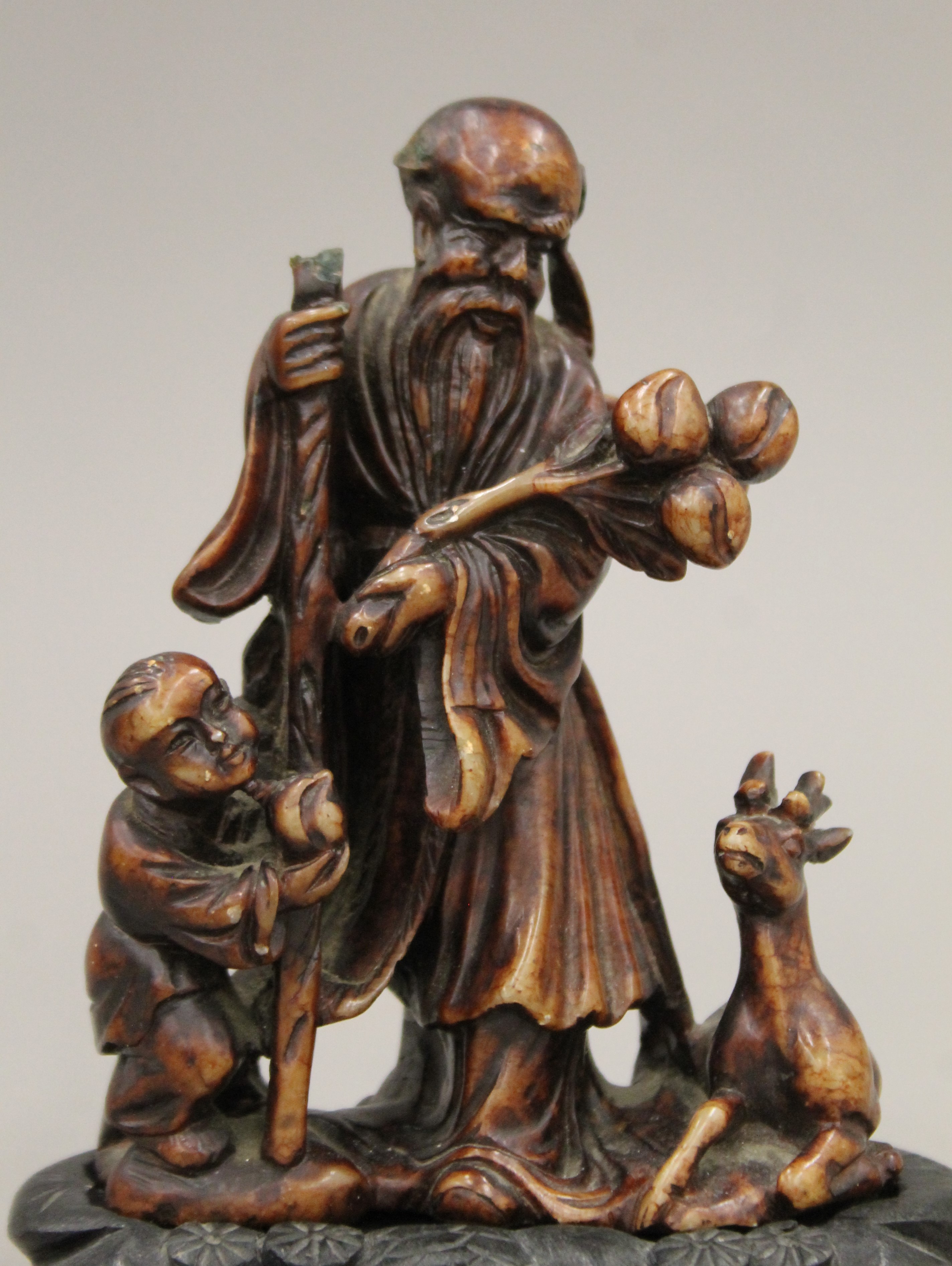 A Chinese carved soapstone group mounted on a carved wooden plinth base. 15 cm high overall. - Image 2 of 9