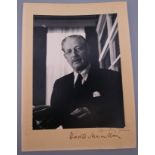 A photograph of Harold Macmillan, on folded card, signed to margin. Image 14.5 cm x 11 cm.