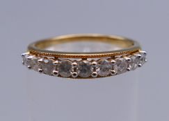 A 9 K gold half eternity ring. Ring size L/M. 2 grammes total weight.