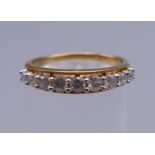 A 9 K gold half eternity ring. Ring size L/M. 2 grammes total weight.