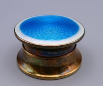 A silver and blue enamelled trinket box. 5.25 cm diameter, 3 cm high.