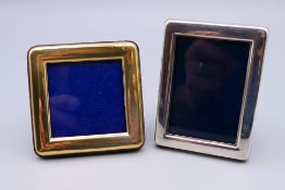 Two small silver photograph frames. One 6 cm x 6 cm, the other 7 cm x 5 cm.