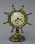 A brass clock formed as a ships wheel. 16 cm high.