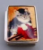 A silver pill box depicting cats. 3 cm x 2.5 cm.