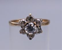 A 9 ct gold cubic zirconia flowerhead ring. Ring size P. 2.2 grammes total weight.