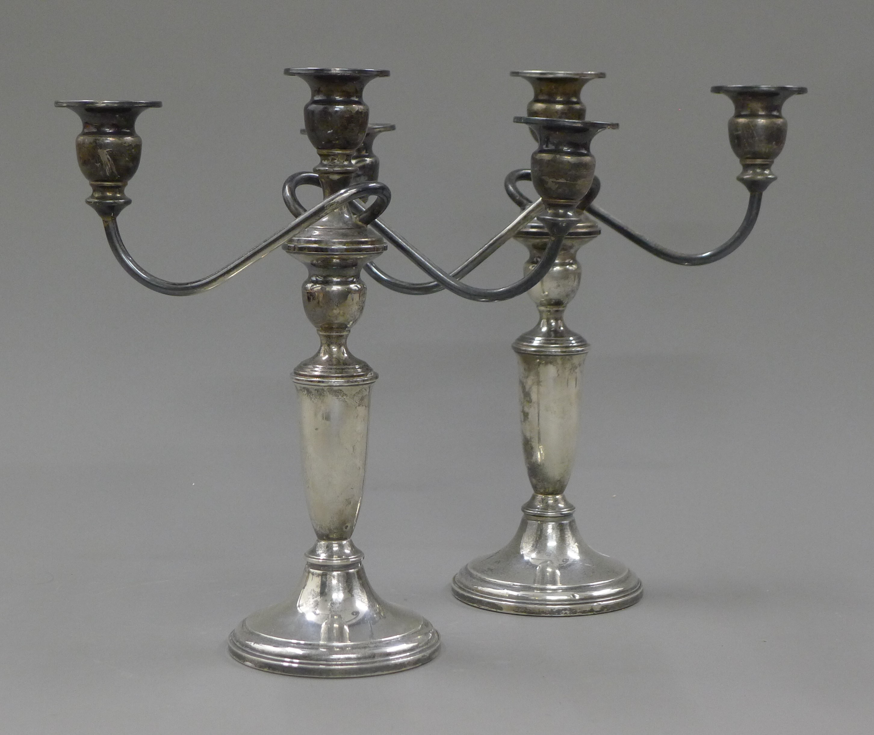 A pair of sterling silver three branch candelabra. 27 cm high.