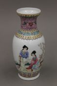 A Chinese famille rose vase decorated with two female scholars in a garden,