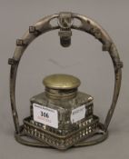 A WMF silver plated horse shoe form desk stand, with associated inkwell. 14 cm high.