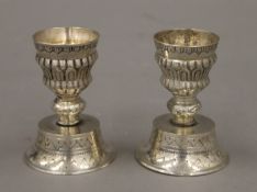 A pair of Eastern silver plated candlesticks. 7.75 cm high.