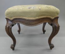 A Victorian upholstered mahogany stool. 44 cm wide.