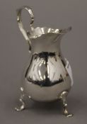 A small silver cream jug. 9.5 cm high. 62.8 grammes.