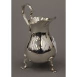 A small silver cream jug. 9.5 cm high. 62.8 grammes.