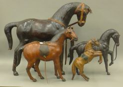 Four leather model horses. The largest 77 cm long.