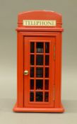 A novelty telephone formed a telephone box. 40 cm high.