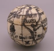 A bone globe compass. 4 cm high.