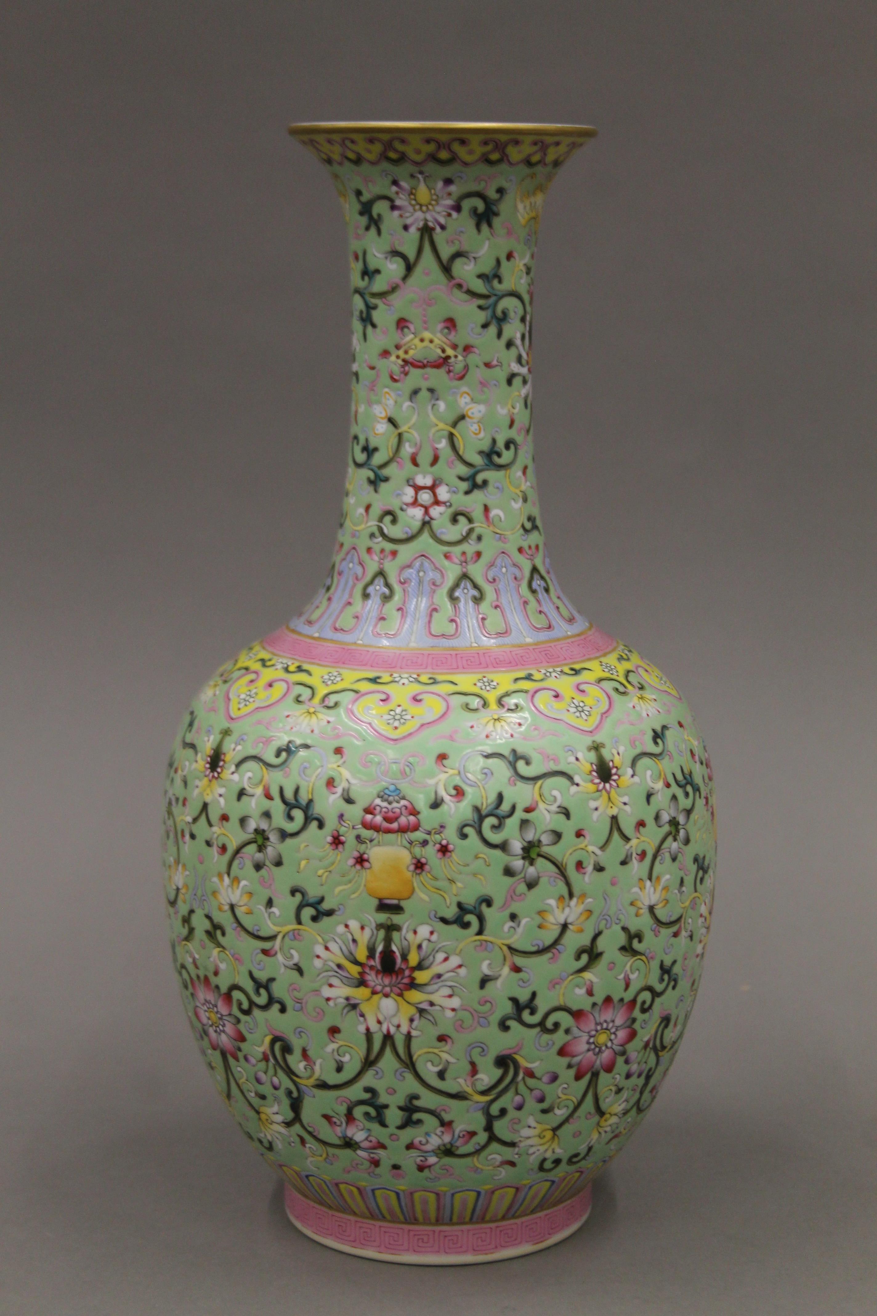 A Chinese green ground porcelain vase with scrolling foliate decoration,