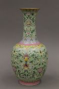 A Chinese green ground porcelain vase with scrolling foliate decoration,