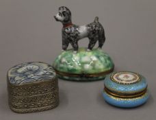 A Limoges porcelain box surmounted with a dog and two other boxes. The former 9 cm high.