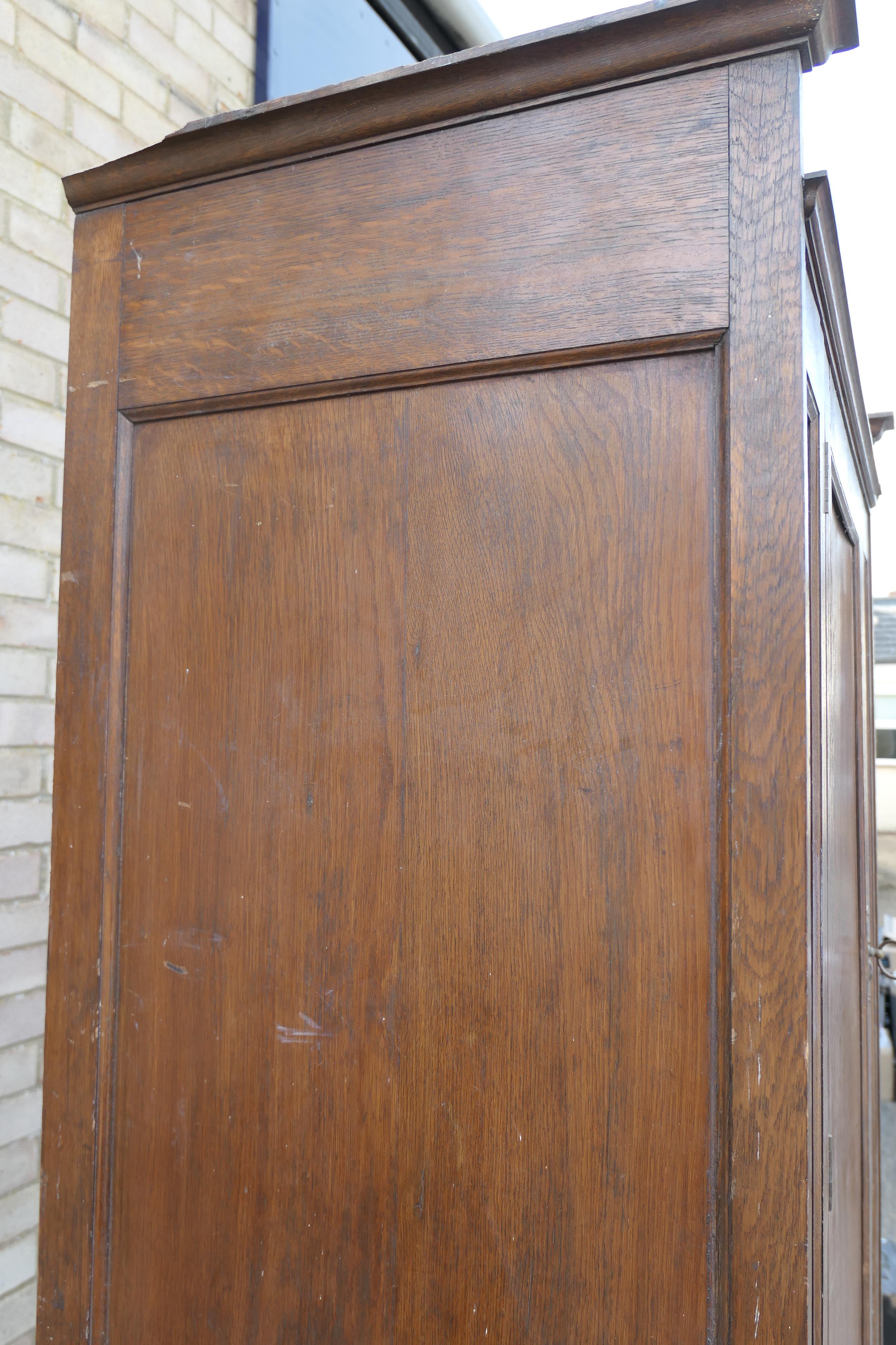 In the Manner of Heals, an Arts and Crafts oak compactum wardrobe. 199.5 cm high x 95 cm wide. - Image 6 of 11