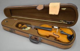 A cased violin and bow. 59 cm long.