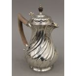 A silver coffee pot. 23 cm high. 697.5 grammes total weight.