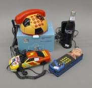 A boxed phone ball and three other novelty telephones, including a Coca Cola bottle.