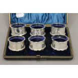 A cased set of six silver napkin rings. 126.8 grammes.