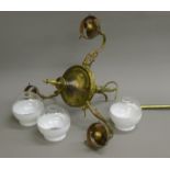 A three-branch brass chandelier with two tone glass shades.