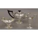 A three-piece Scottish silver tea set by Hamilton and Inches. The tea pot 26 cm long. 778.