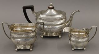 A Georgian silver three-piece tea set. The tea pot 28 cm long. 1014.2 grammes total weight.