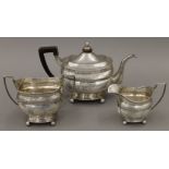 A Georgian silver three-piece tea set. The tea pot 28 cm long. 1014.2 grammes total weight.