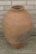 A terracotta olive oil pot. 59 cm high.